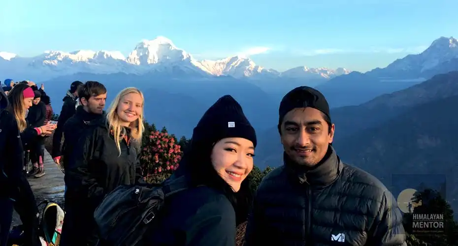 Happy client is posing a photo with our guide at Poon Hill