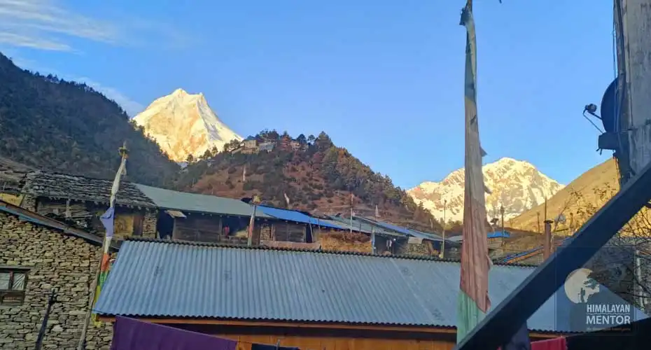 Local village with the glowing Mount Manaslu in the background